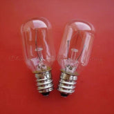 Two clear 24V 10W E12 base miniature light bulbs on red background